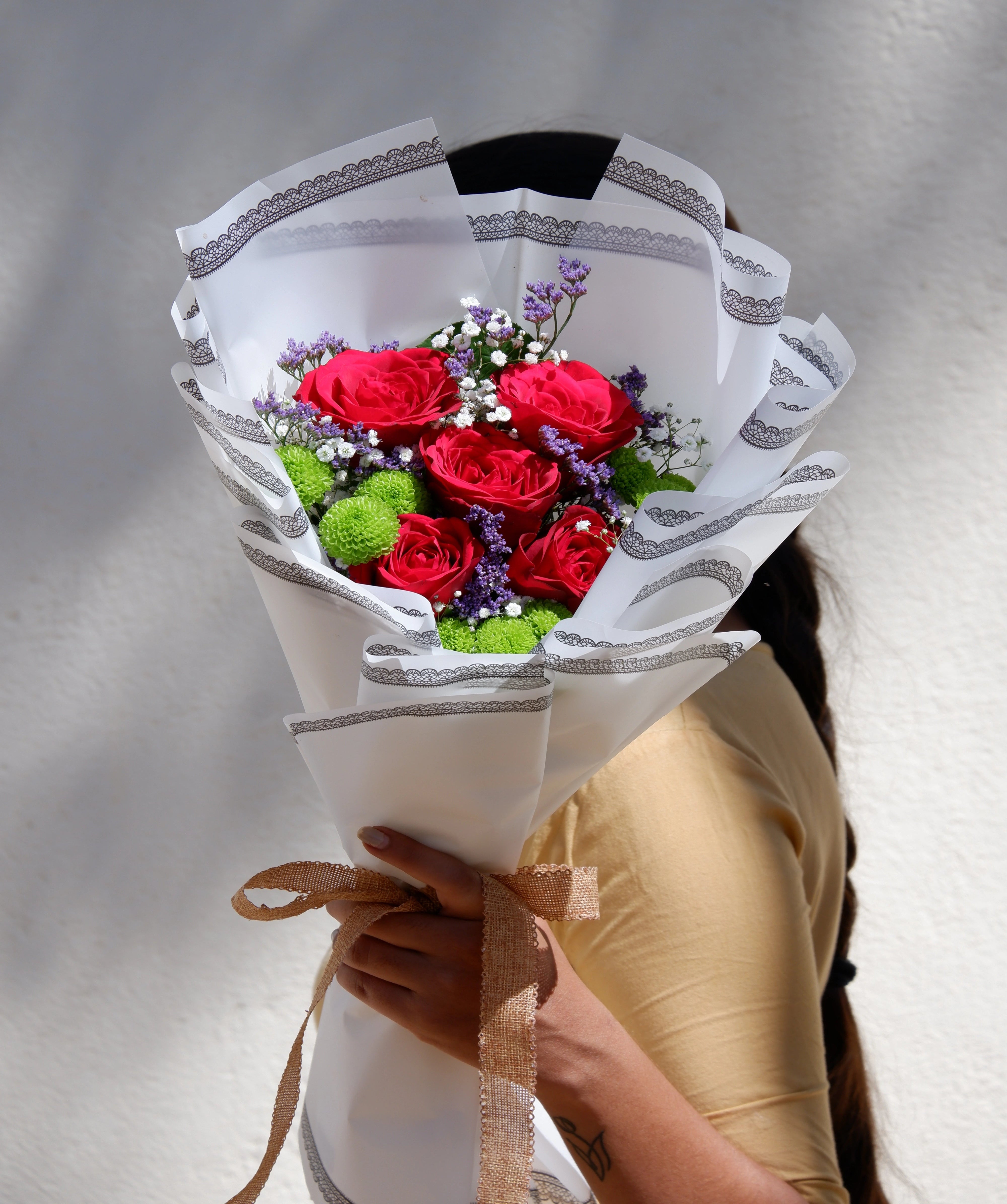 A stunning bouquet of Red Rose with green buttons and fillers